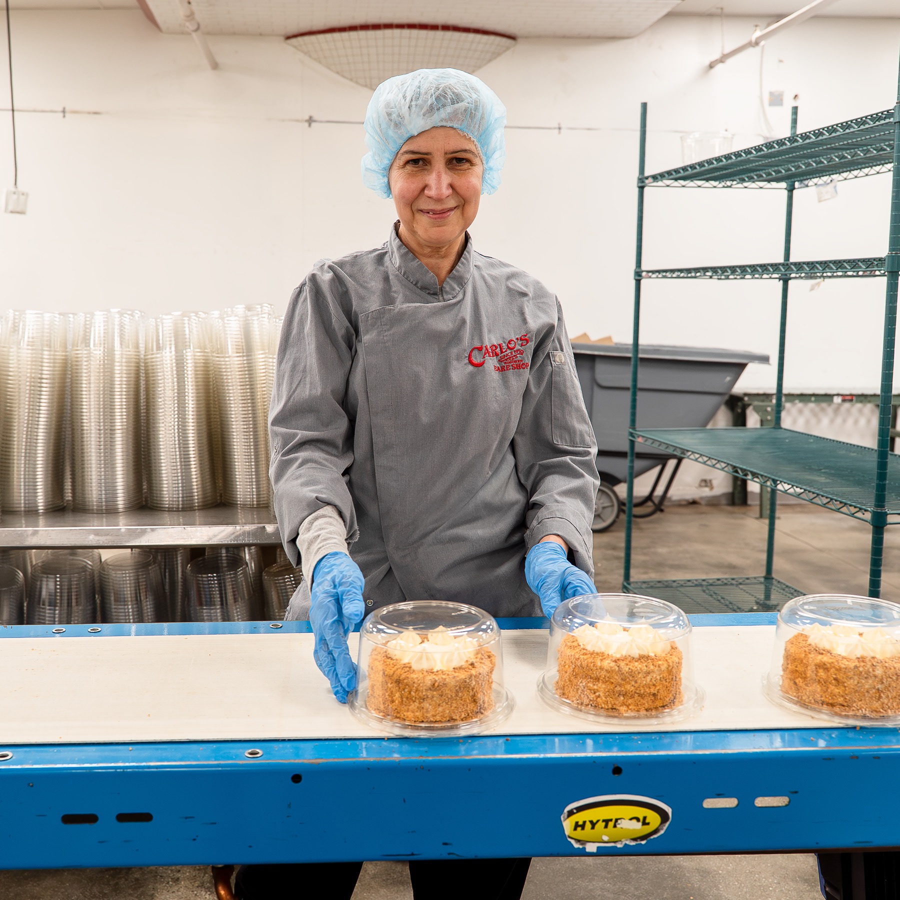 Carlo's Bakery team member packaging cakes