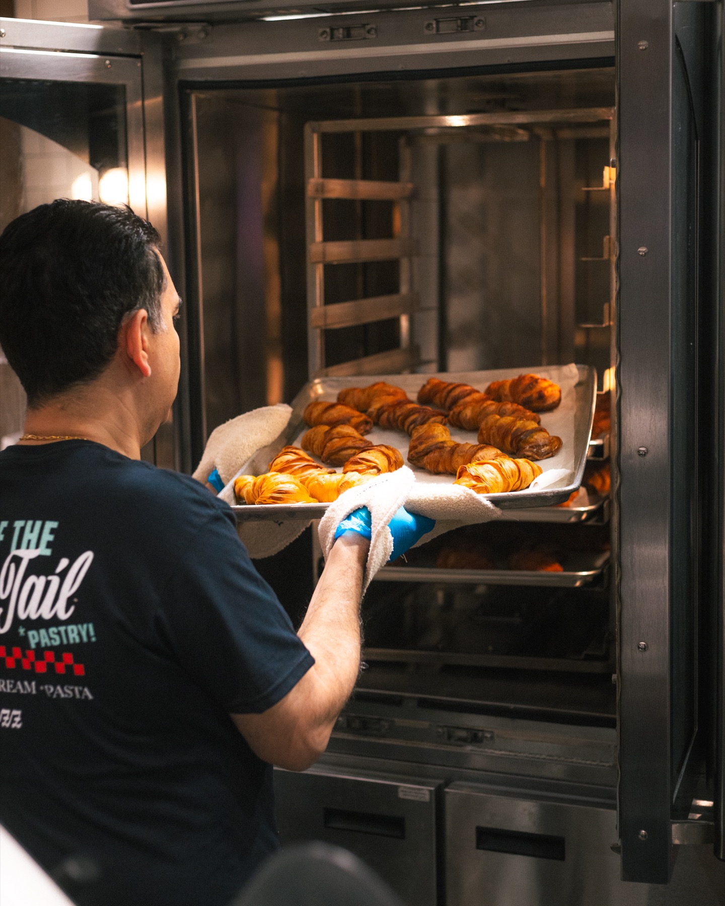 Carlo's Bakery team member baking fresh pastries